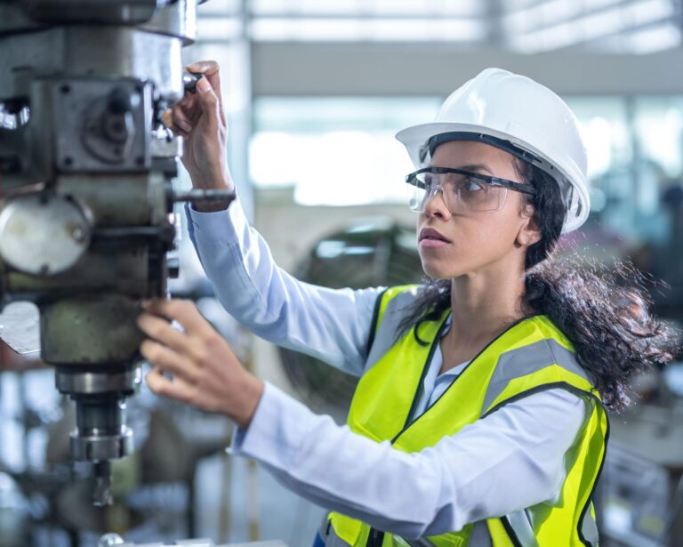 Mechanical engineer inspecting industrial machinery and equipment in a manufacturing facility