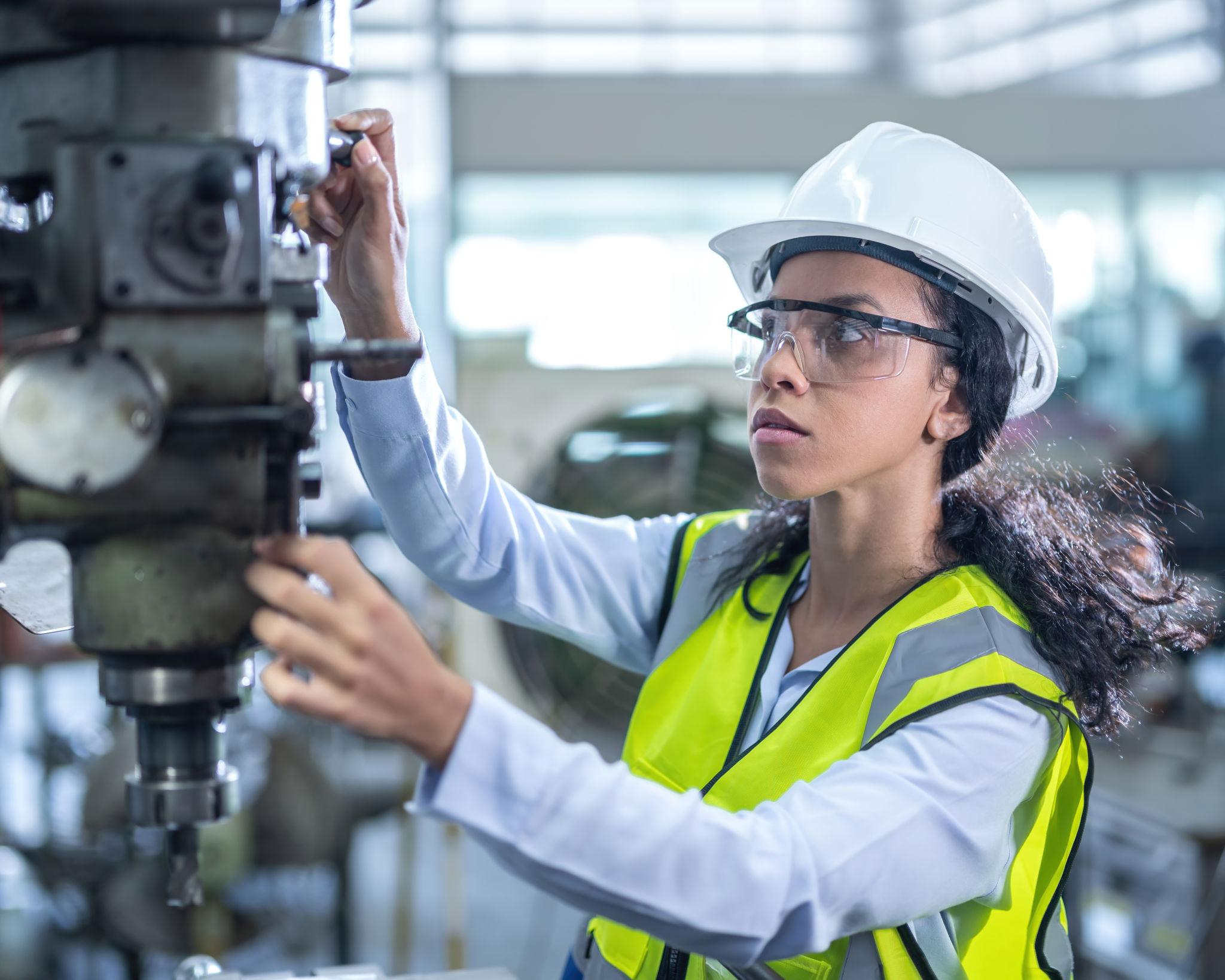 Mechanical engineer inspecting industrial machinery and equipment in a manufacturing facility